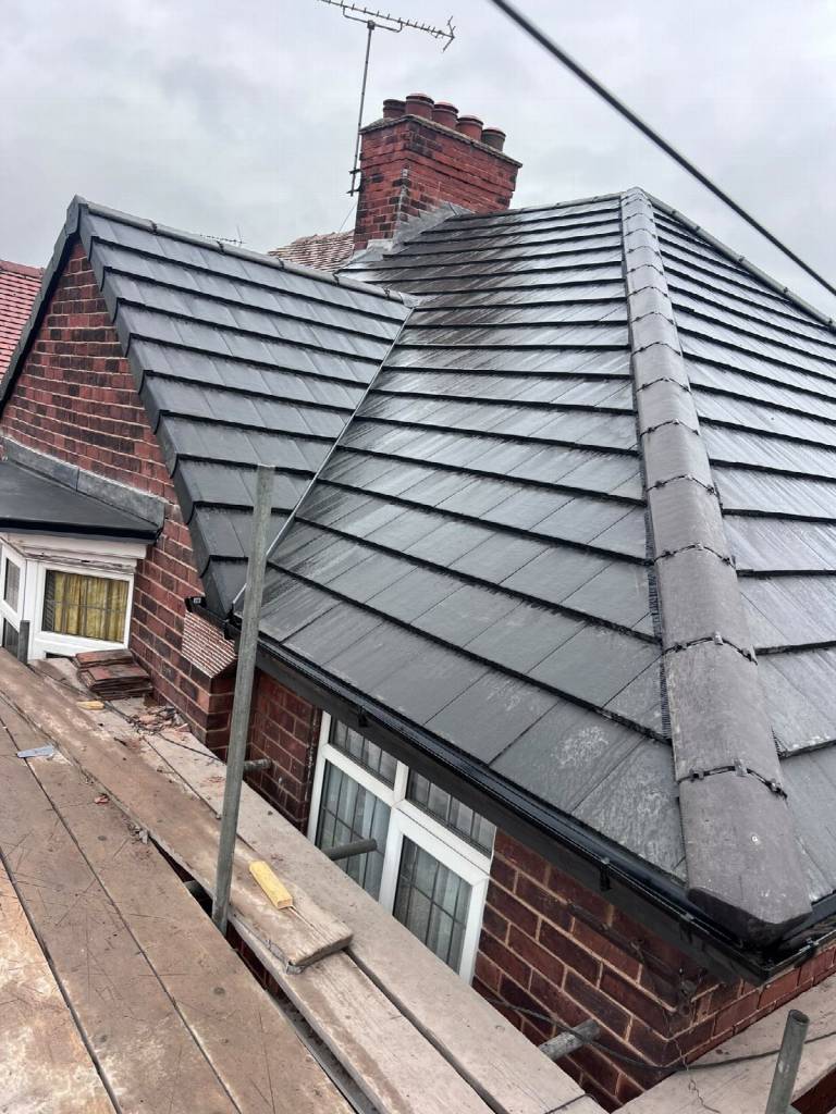 After: completed new roof in Worksop with Russell grey concrete interlocking tiles and matching grey ridge tiles by Gold Zone Roofing